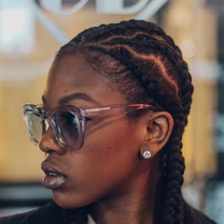 Freshly finished cornrow braids, seen in profile