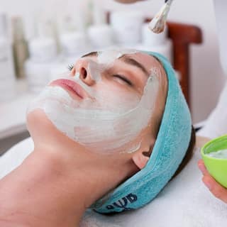 A face mask being applied during a facial